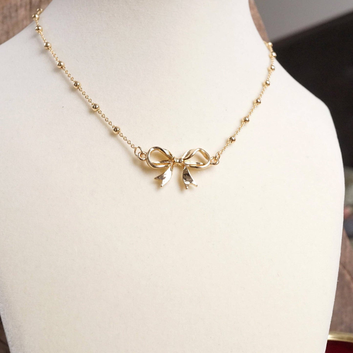 Fancy Bow Necklace - Short dainty station chain in gold tone