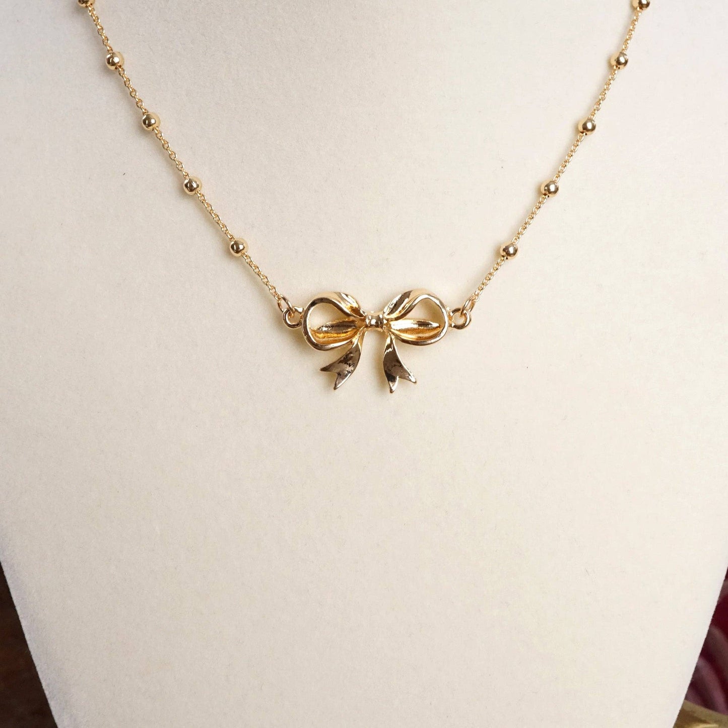 Fancy Bow Necklace - Short dainty station chain in gold tone